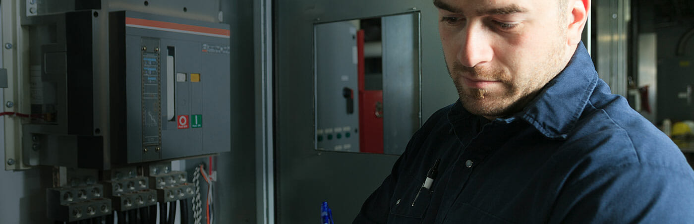 Photo of man in front of an electrical panel