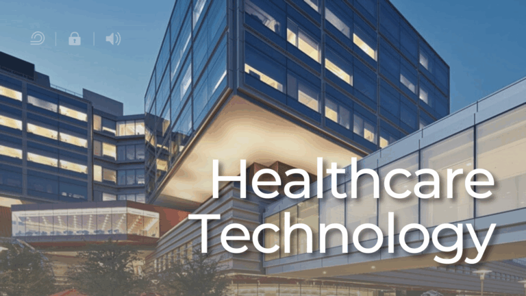 Stanford Health Care hospital with glass skybridge and courtyard at dusk.