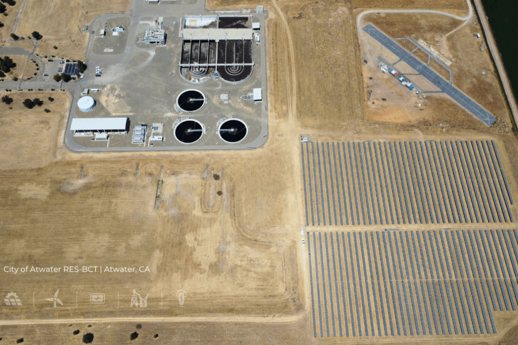 Aerial view of the City of Atwater RES-BCT project in Atwater, California, showing a large ground-mounted solar PV array adjacent to a wastewater treatment facility.