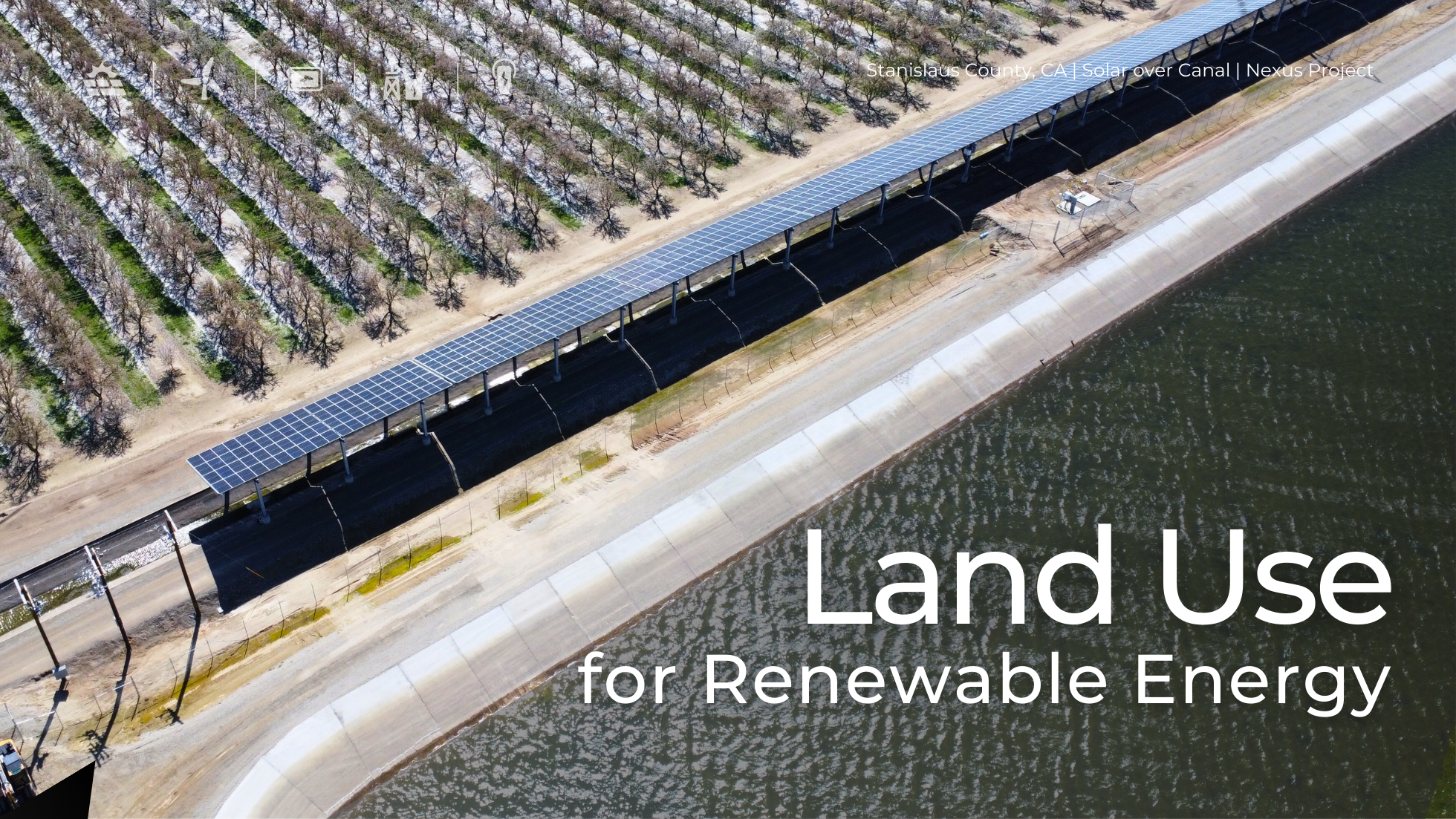 Aerial view of a solar-over-canal installation in Stanislaus County, CA, as part of Project Nexus. Solar panels are mounted above a canal, adjacent to an agricultural field, showcasing innovative land use for renewable energy and water conservation.